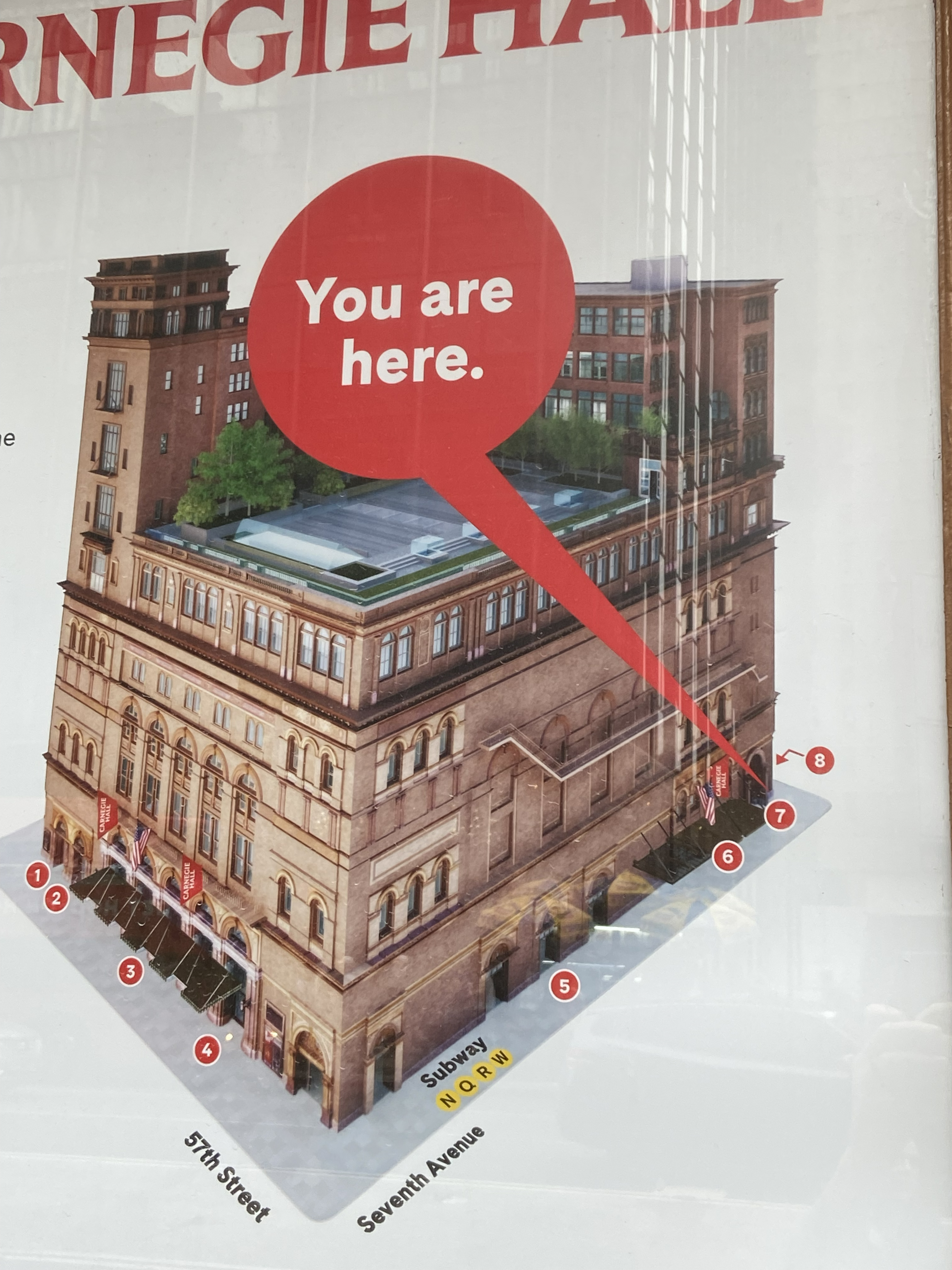 Photo of a 'you are here' poster outside Carnegie Hall.